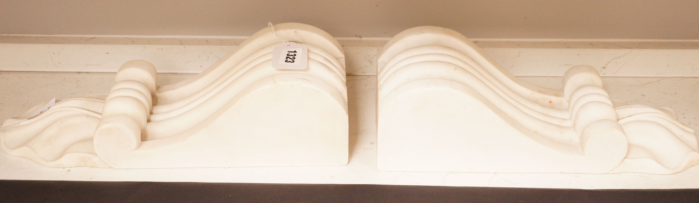 A pair of carved white marble scrolling corbels, 38x14cm